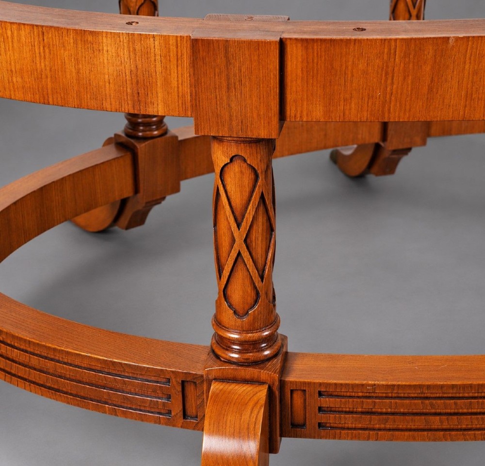 A large oval burr walnut extending dining table with inlaid crossbanding and pedestal legs terminating in brass castors. View V