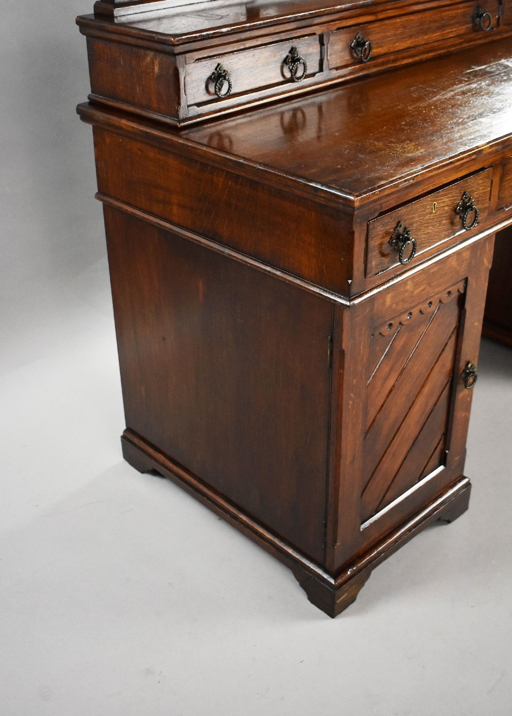 A Victorian Gothic Revival oak dressing table featuring a central pointed arched mirror, trefoil tracery carvings, multiple drawers, and pedestal cupboards with diagonal wood panelling. View VIII