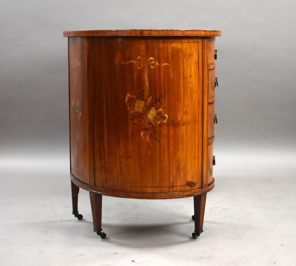 An Edwardian satinwood kidney-shaped writing desk featuring nine hand-painted drawers with brass ring handles and tapered legs on castors. View III