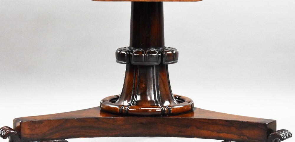 A William IV circular rosewood tilt-top breakfast table showing a book-matched grain pattern displayed vertically above a triform base. View VI