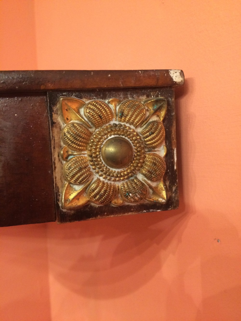 A set of wall-mounted Georgian mahogany corner shelves featuring bow-fronted fronts with brass rosette mounts on the corners. View V