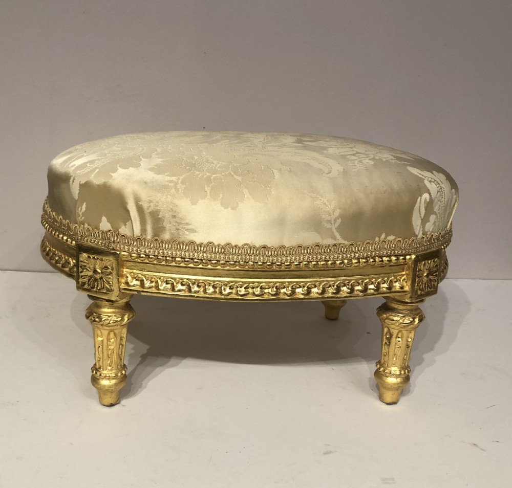 19th century oval carved giltwood footstool.