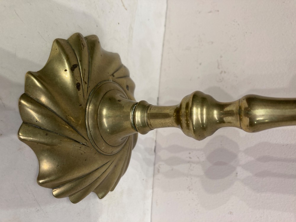 Pair of Georgian brass candlesticks. View II