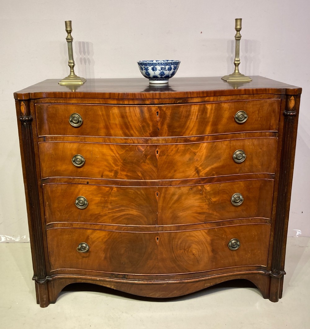 Antique serpentine  mahogany chest of drawers.