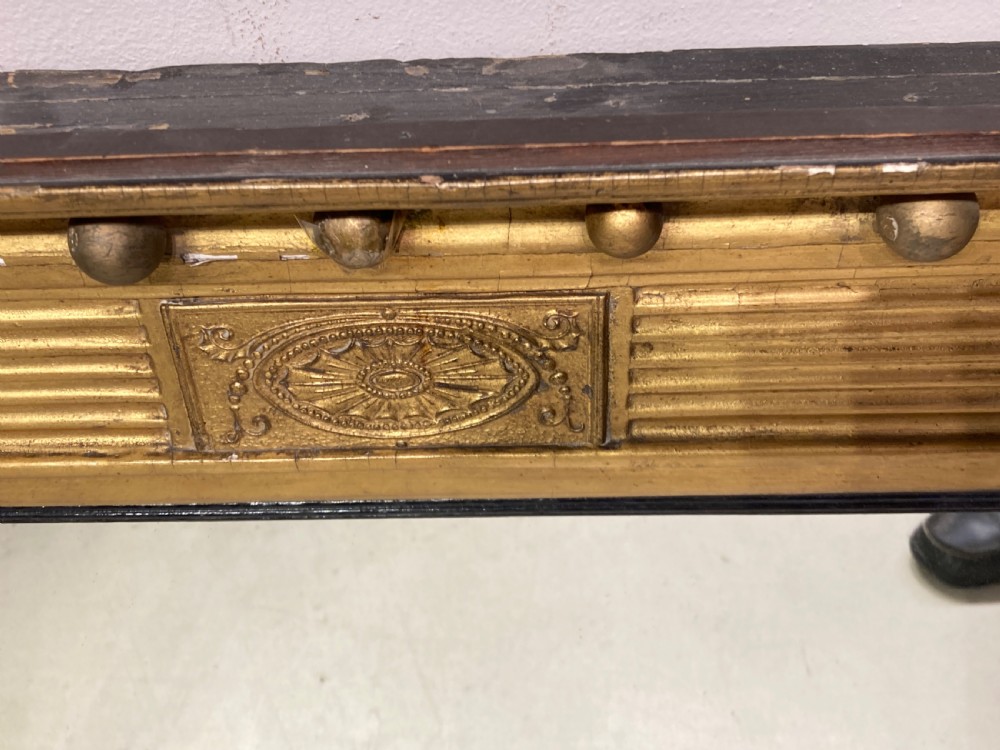 A horizontal Regency period giltwood overmantel mirror featuring a three-plate glass layout, spiral-twist side columns, a ball-frieze upper cornice, and ebonised inner borders. View II