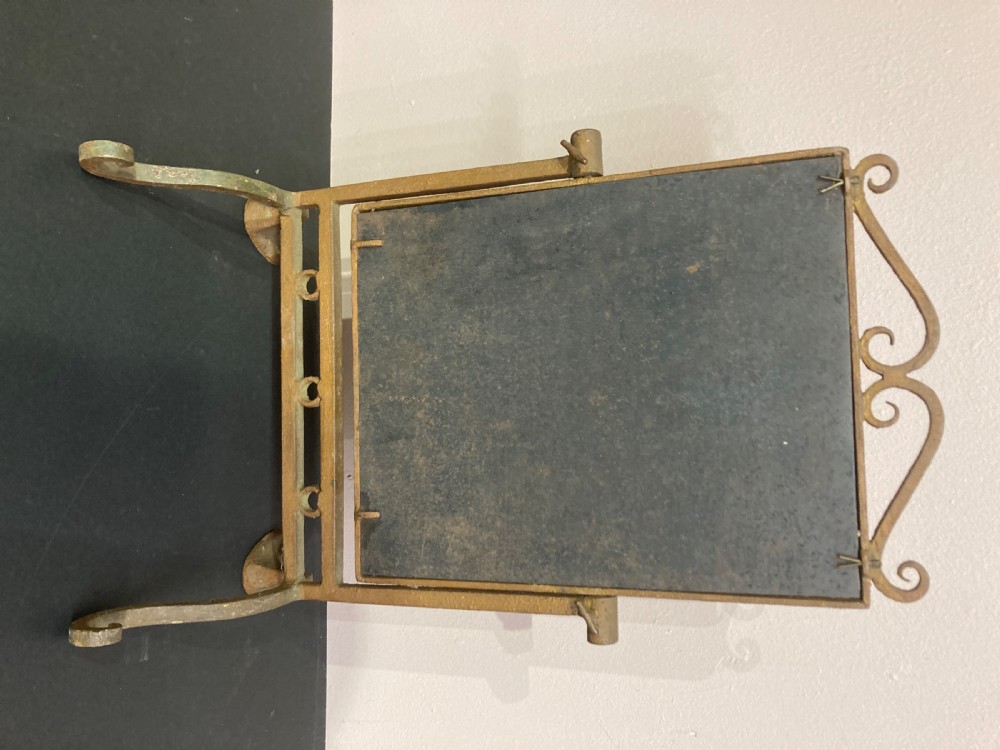 A rectangular gilded metal dressing table mirror featuring a scrolled crest, swivel frame, and splayed paw feet with foxed glass. View IV
