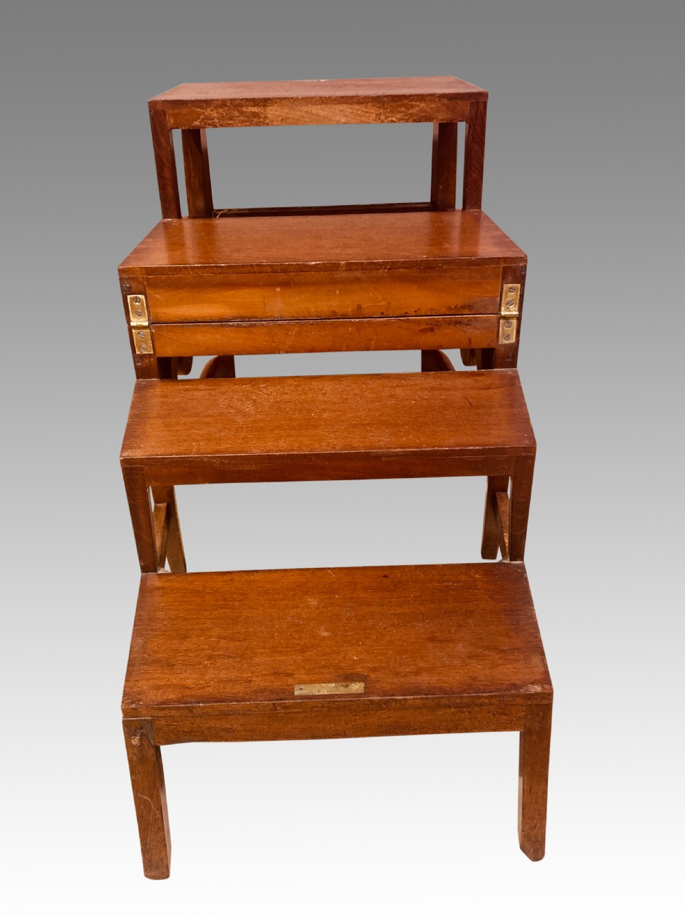 A Georgian mahogany armchair featuring a woven cane seat, scrolled armrests, curved legs, and a hinged convertible mechanism for library steps. View III