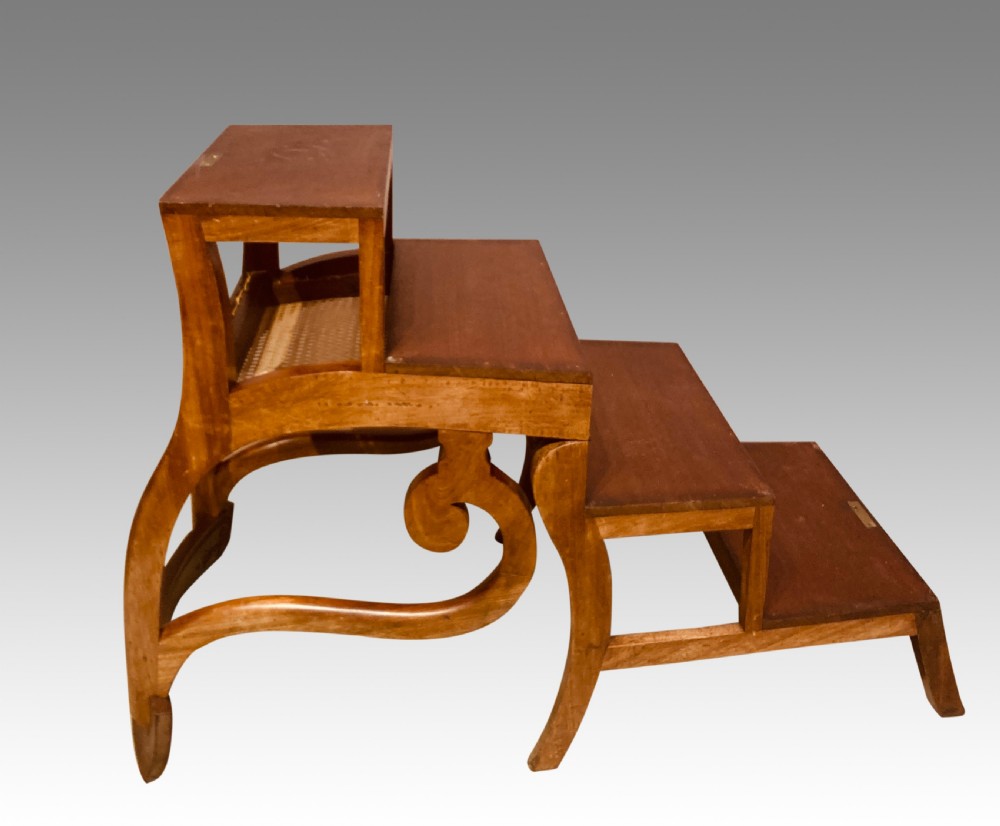 A Georgian mahogany armchair featuring a woven cane seat, scrolled armrests, curved legs, and a hinged convertible mechanism for library steps. View IV