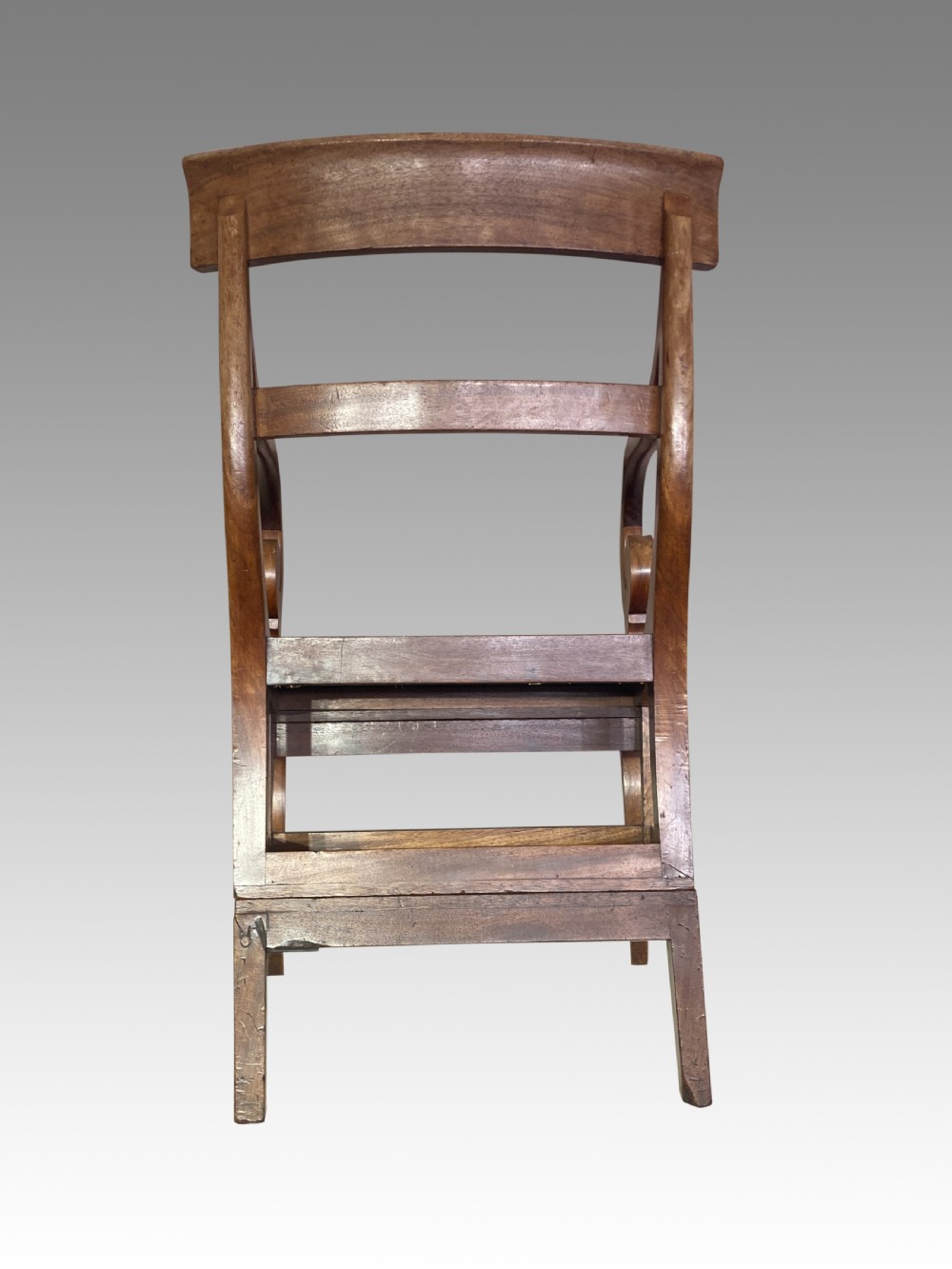 A Georgian mahogany armchair featuring a woven cane seat, scrolled armrests, curved legs, and a hinged convertible mechanism for library steps. View VIII