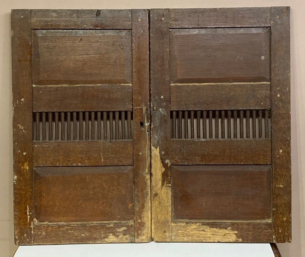 A pair of Georgian pine cupboard doors featuring a scumbled paint finish, recessed panels, central spindle grilles, and brass escutcheons. View II