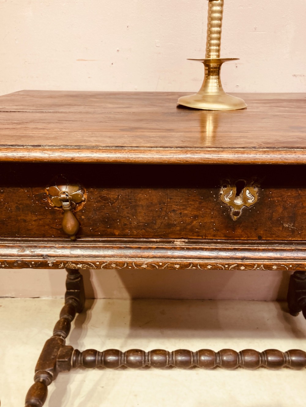 An 18th-century oak and elm side table featuring a single drawer with brass handles, turned legs, and a bobbin stretcher. View II