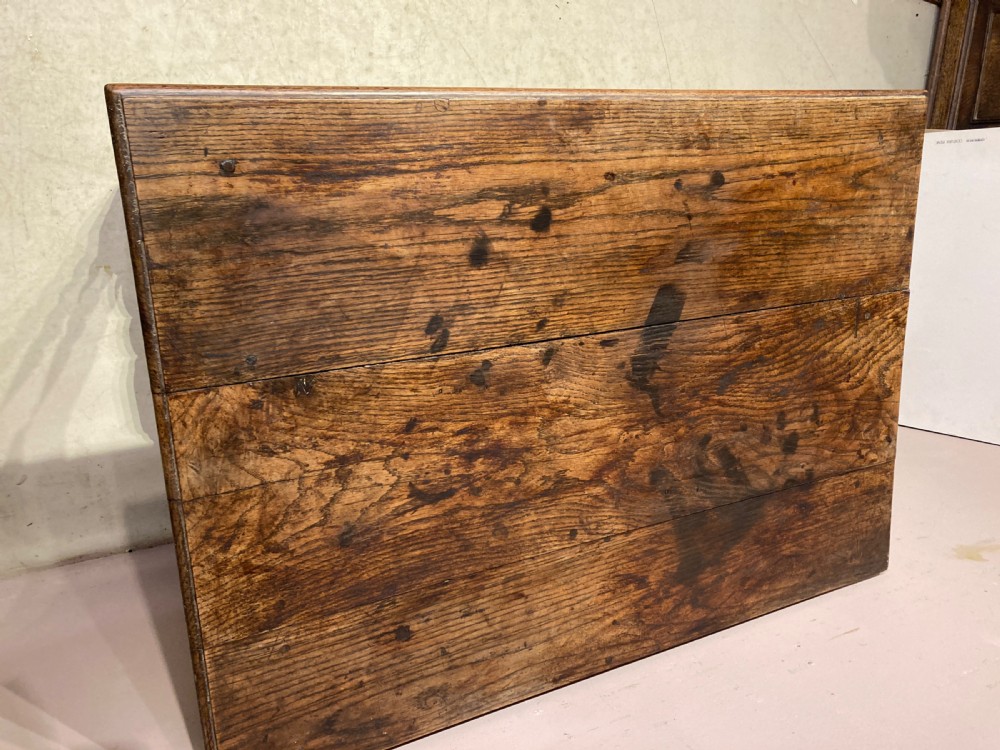 An 18th-century oak and elm side table featuring a single drawer with brass handles, turned legs, and a bobbin stretcher. View V
