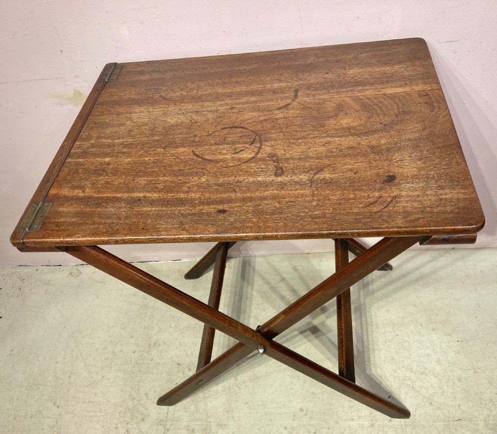 A Georgian mahogany folding butler table featuring a crossed X-frame support base and a smooth rectangular wooden top with corner brass hinges. View III