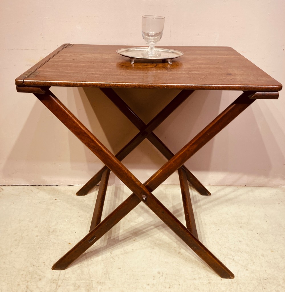 A Georgian mahogany folding butler table featuring a crossed X-frame support base and a smooth rectangular wooden top with corner brass hinges. View V