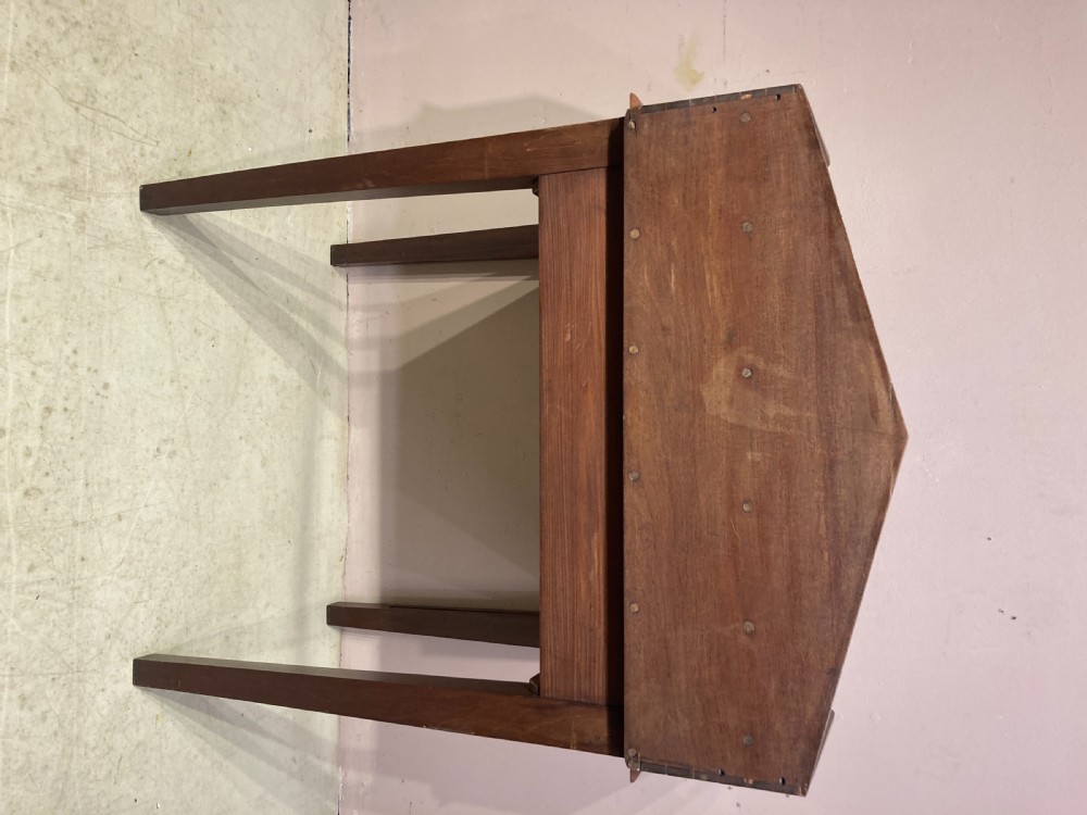 A Georgian mahogany writing table featuring a shaped gallery back shelf, a rounded tamboured front section, and square tapered legs. View IV