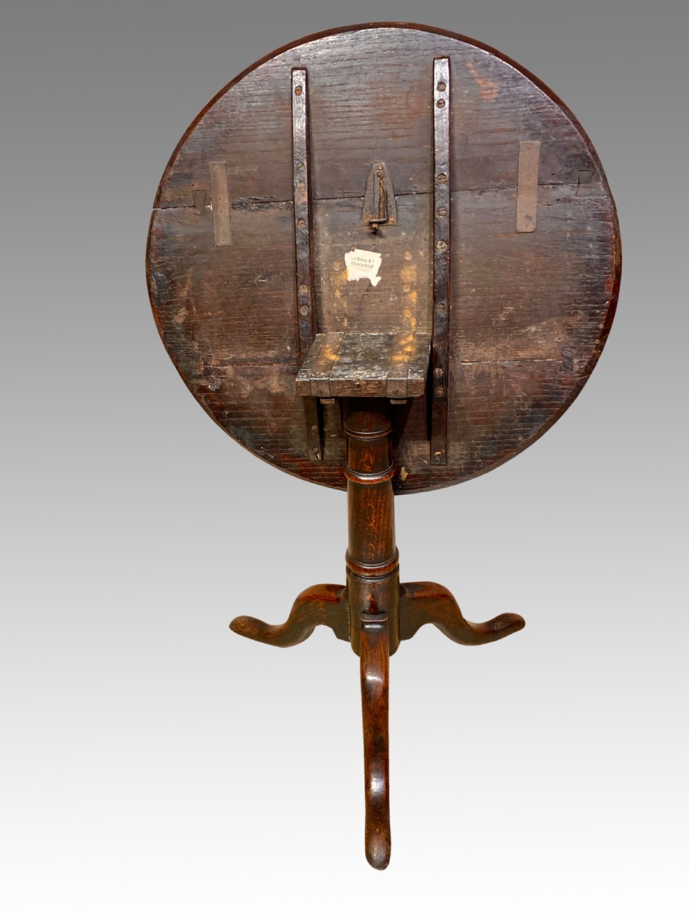An 18th-century Georgian circular oak tripod table featuring a turned central pedestal column resting on three downswept legs. View II