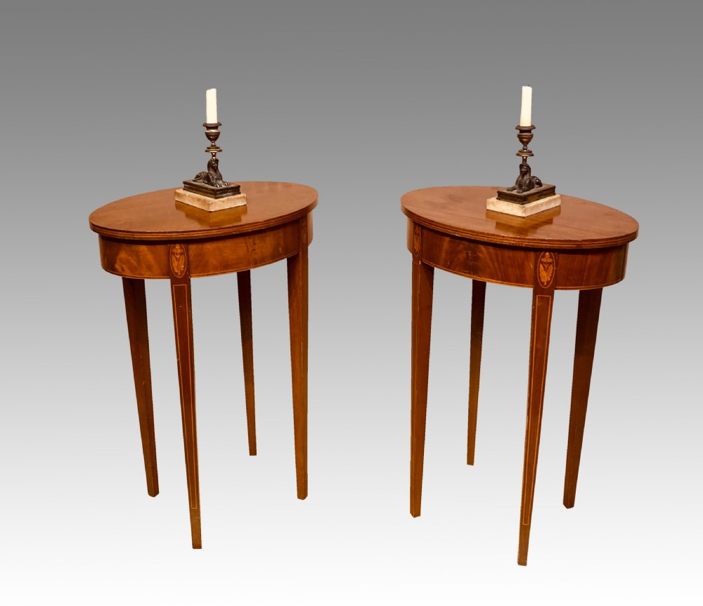 Pair of oval mahogany lamp tables.