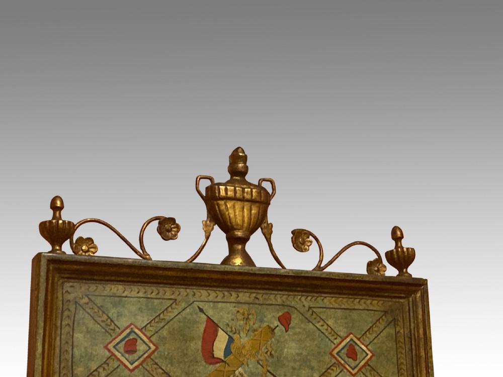 A tall Neoclassical French pier mirror featuring a green painted frame, gilded beaded trim, an urn motif cresting, and two hand-painted decorative panels. View III