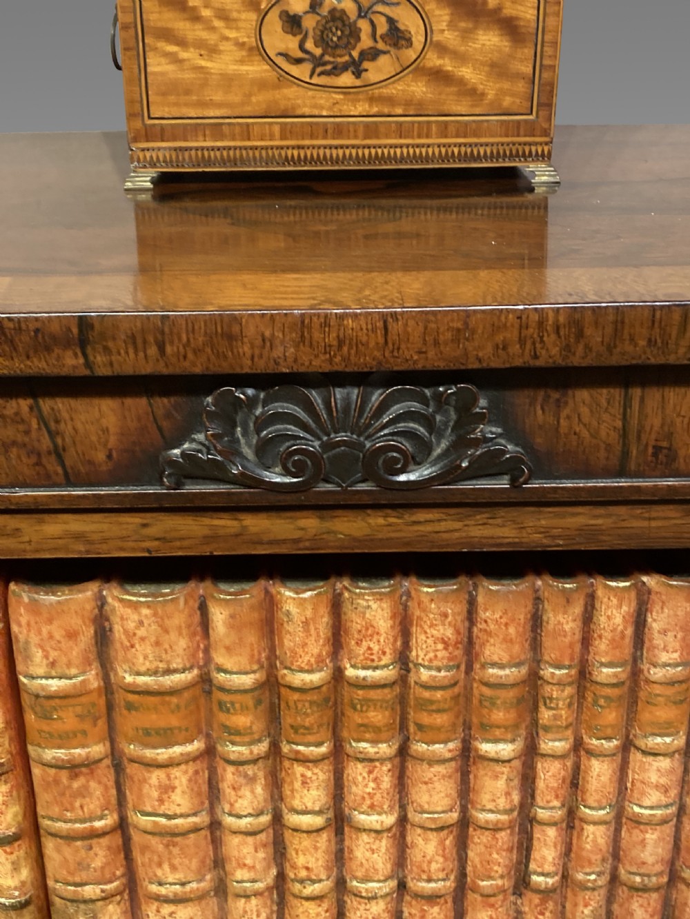 A tall Neoclassical French pier mirror featuring a green painted frame, gilded beaded trim, an urn motif cresting, and two hand-painted decorative panels. View V