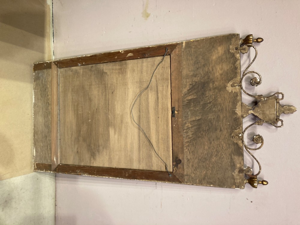 A tall Neoclassical French pier mirror featuring a green painted frame, gilded beaded trim, an urn motif cresting, and two hand-painted decorative panels. View VI