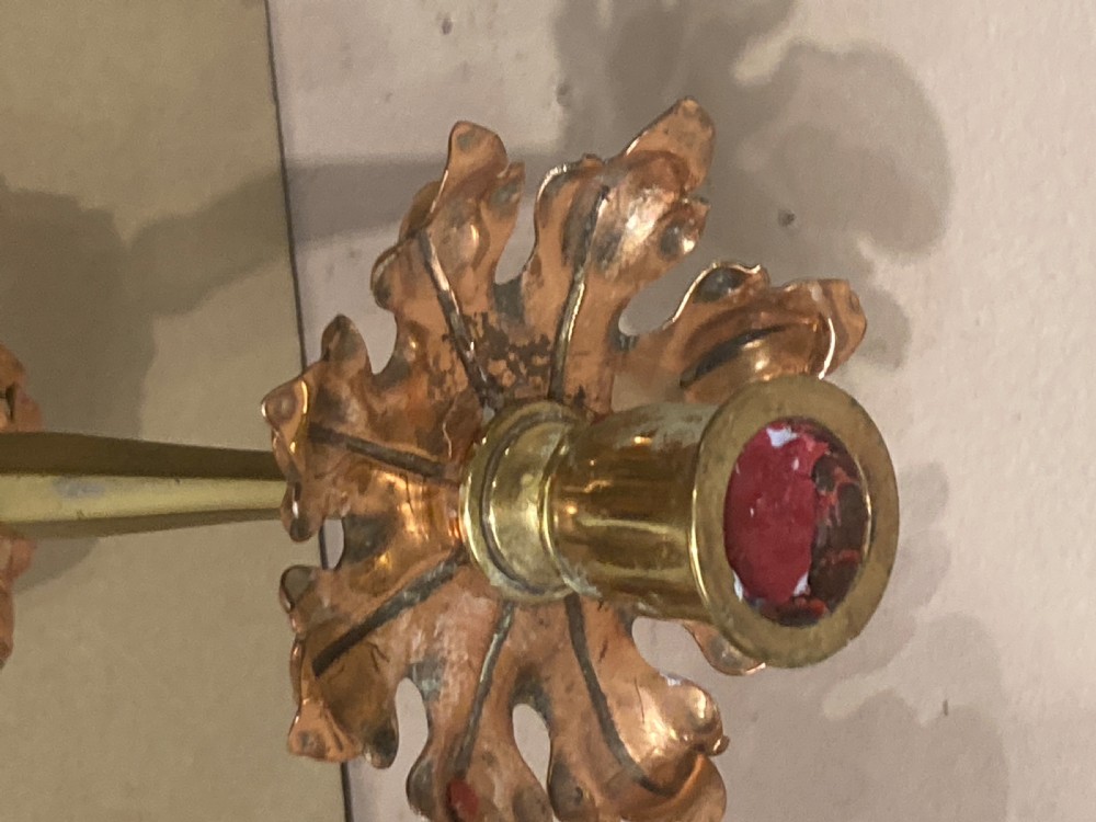 A pair of brass and copper Arts and Crafts candlesticks featuring stylised leaf sconces, slender tapered shafts, and pierced botanical bases. View III