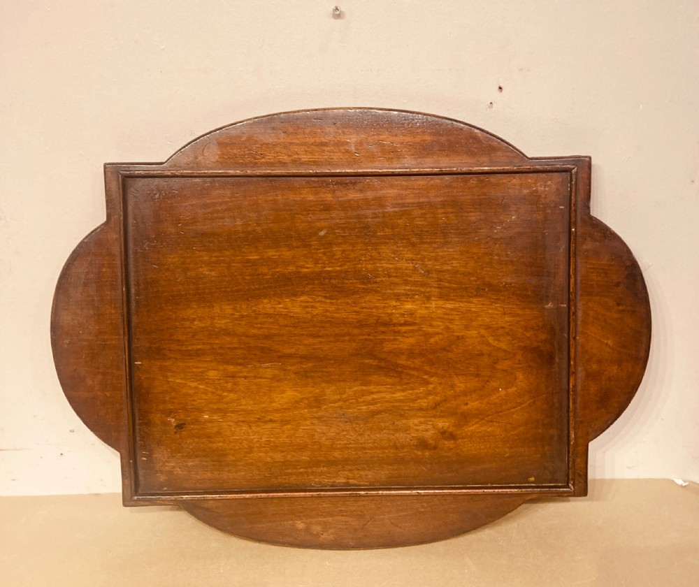 An oval burr walnut coffee table featuring a shaped tray rim and carved cabriole legs ending in pad feet. View III