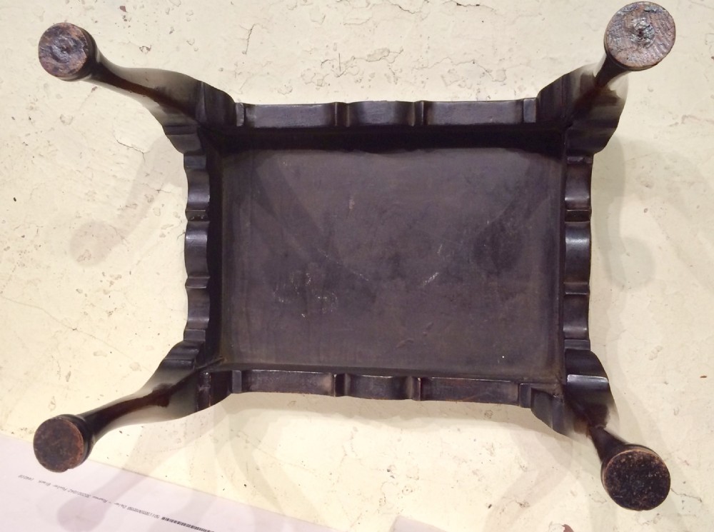 An oval burr walnut coffee table featuring a shaped tray rim and carved cabriole legs ending in pad feet. View IV