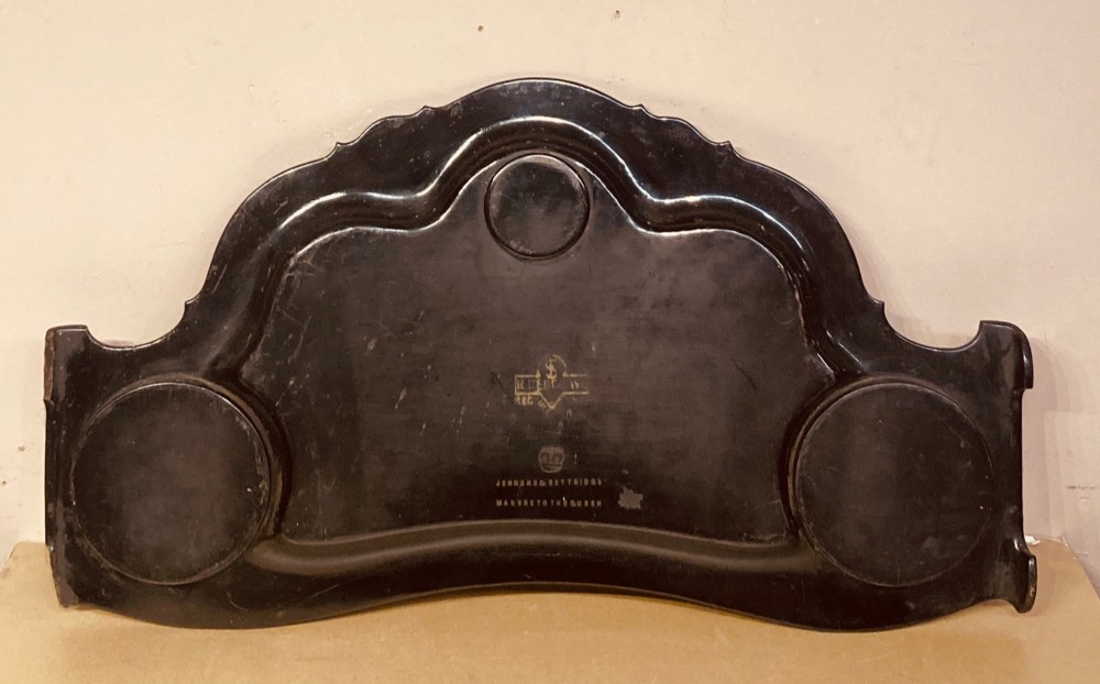 A black lacquered Georgian papier-mache tray featuring mother of pearl inlay along the scalloped rim and a central crest motif. View II