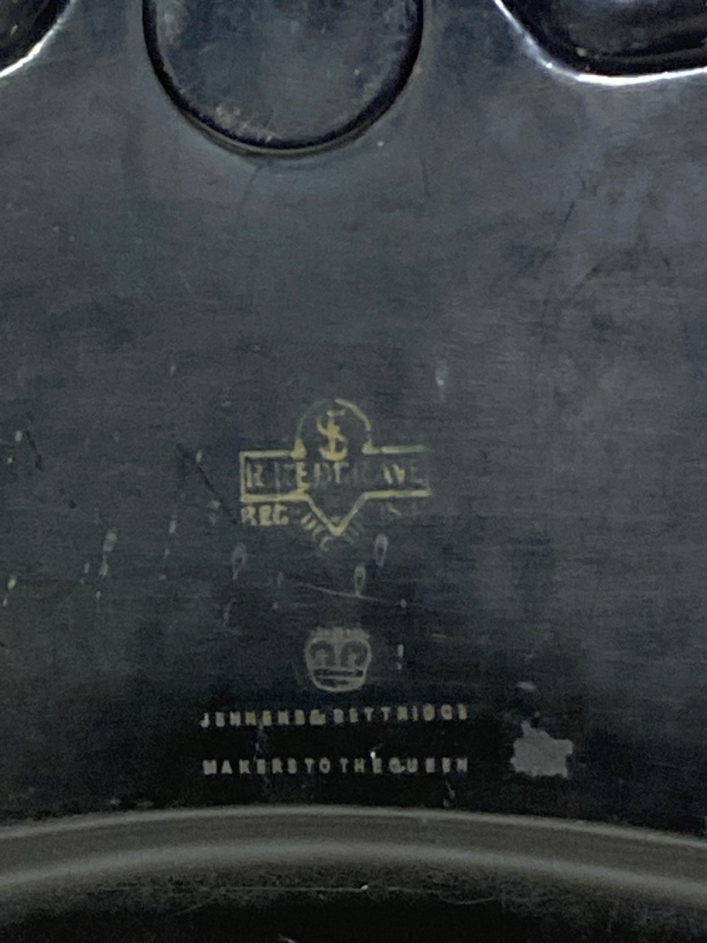 A black lacquered Georgian papier-mache tray featuring mother of pearl inlay along the scalloped rim and a central crest motif. View III