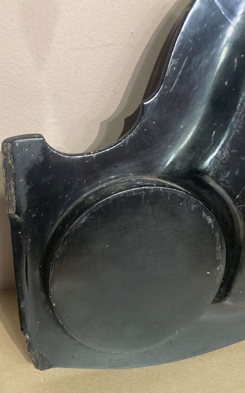 A black lacquered Georgian papier-mache tray featuring mother of pearl inlay along the scalloped rim and a central crest motif. View IV