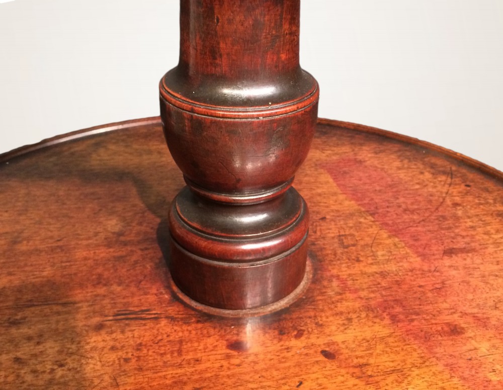 A three-tiered Georgian mahogany dumb waiter featuring graduated circular trays supported by a turned column and tripod base. View III