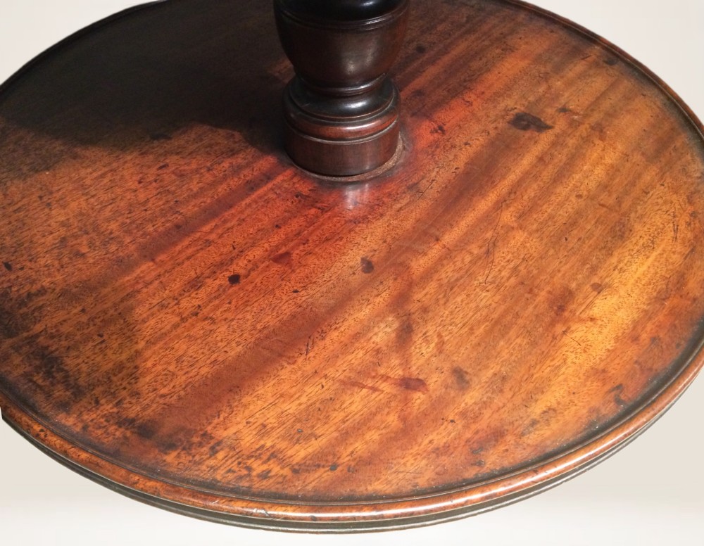 A three-tiered Georgian mahogany dumb waiter featuring graduated circular trays supported by a turned column and tripod base. View IV