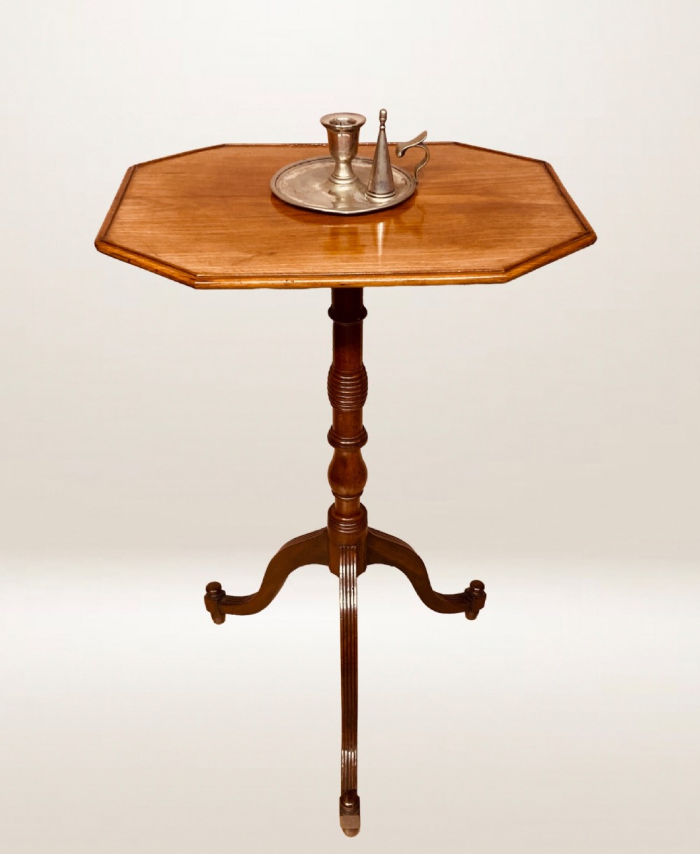 A Georgian mahogany lamp table featuring an octagonal top supported by a turned central column on a tripod base.