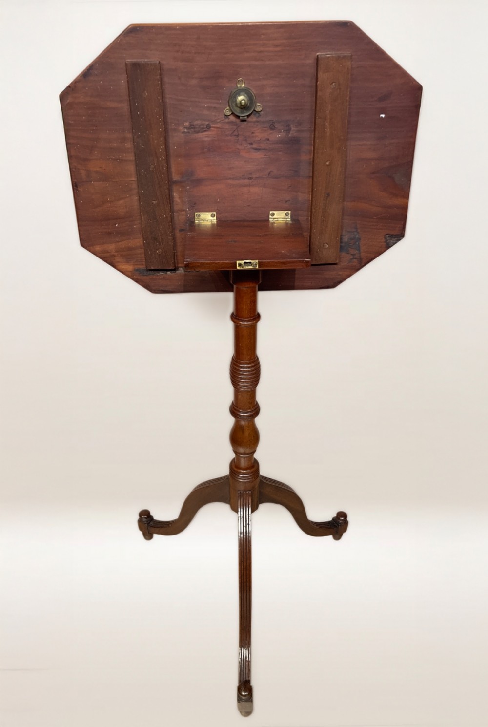 A Georgian mahogany lamp table featuring an octagonal top supported by a turned central column on a tripod base. View IV