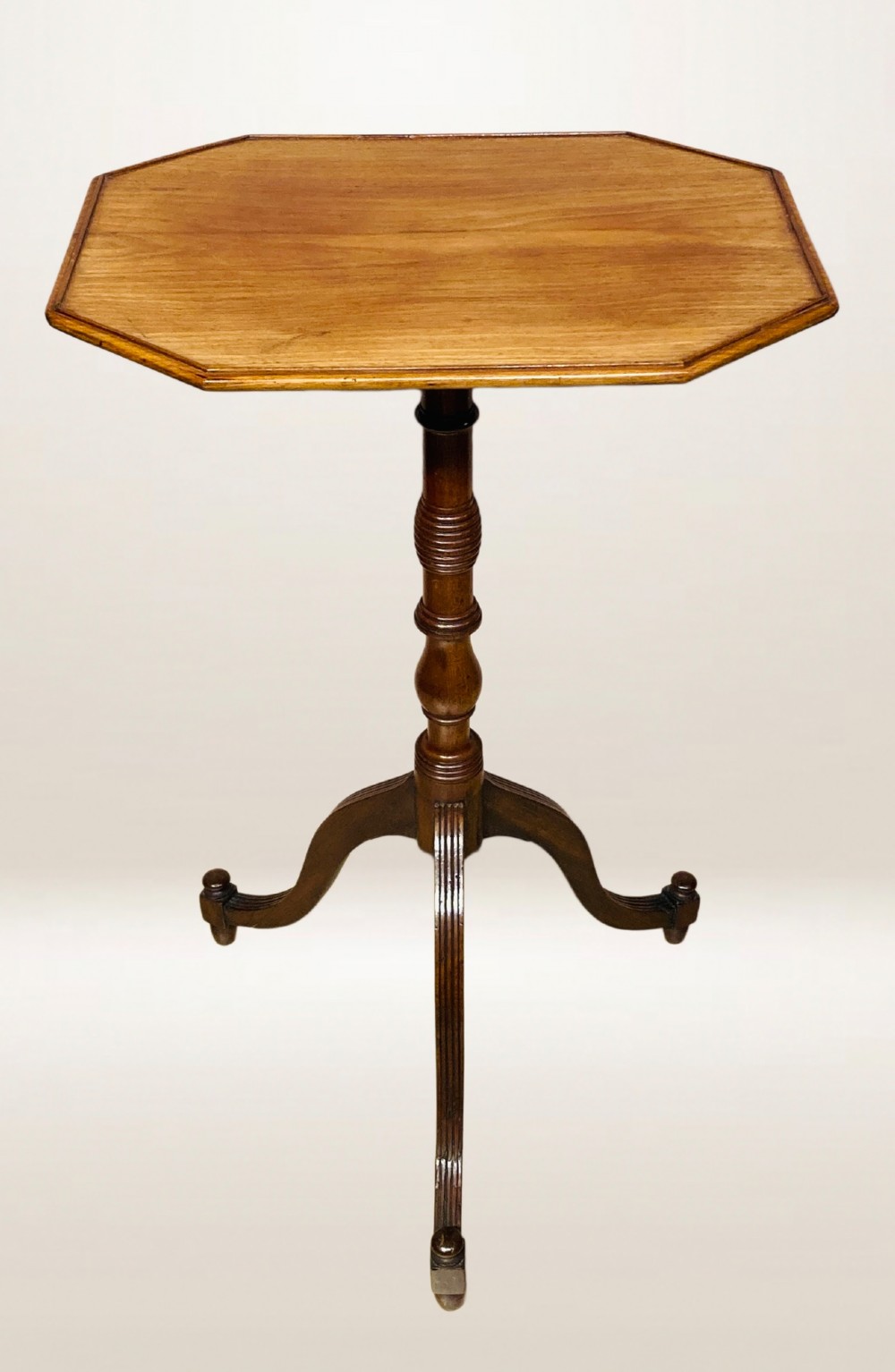 A Georgian mahogany lamp table featuring an octagonal top supported by a turned central column on a tripod base. View VI