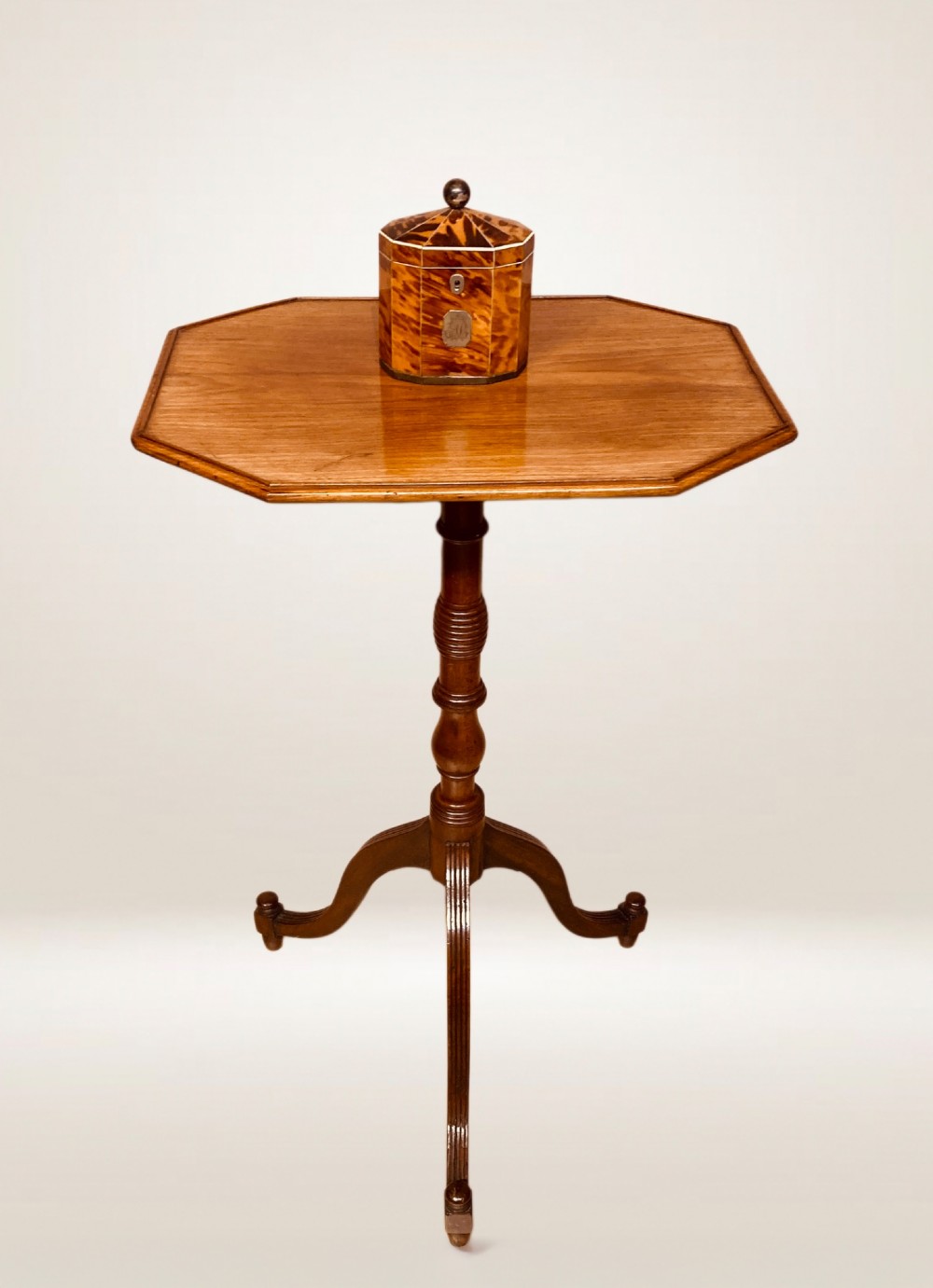A Georgian mahogany lamp table featuring an octagonal top supported by a turned central column on a tripod base. View VII