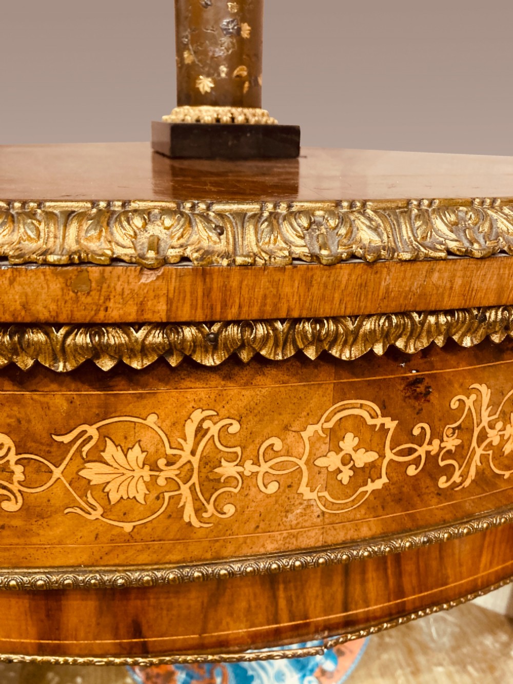 A pair of Victorian inlaid walnut corner cabinets featuring curved glass display doors, decorative floral marquetry, and gilt bronze mounts. View V
