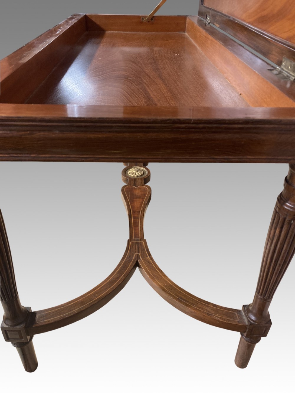 A 19th-century rosewood rectangular music bench featuring a cream upholstered seat, fluted legs, and a gilt decorative central panel on the frieze. View III
