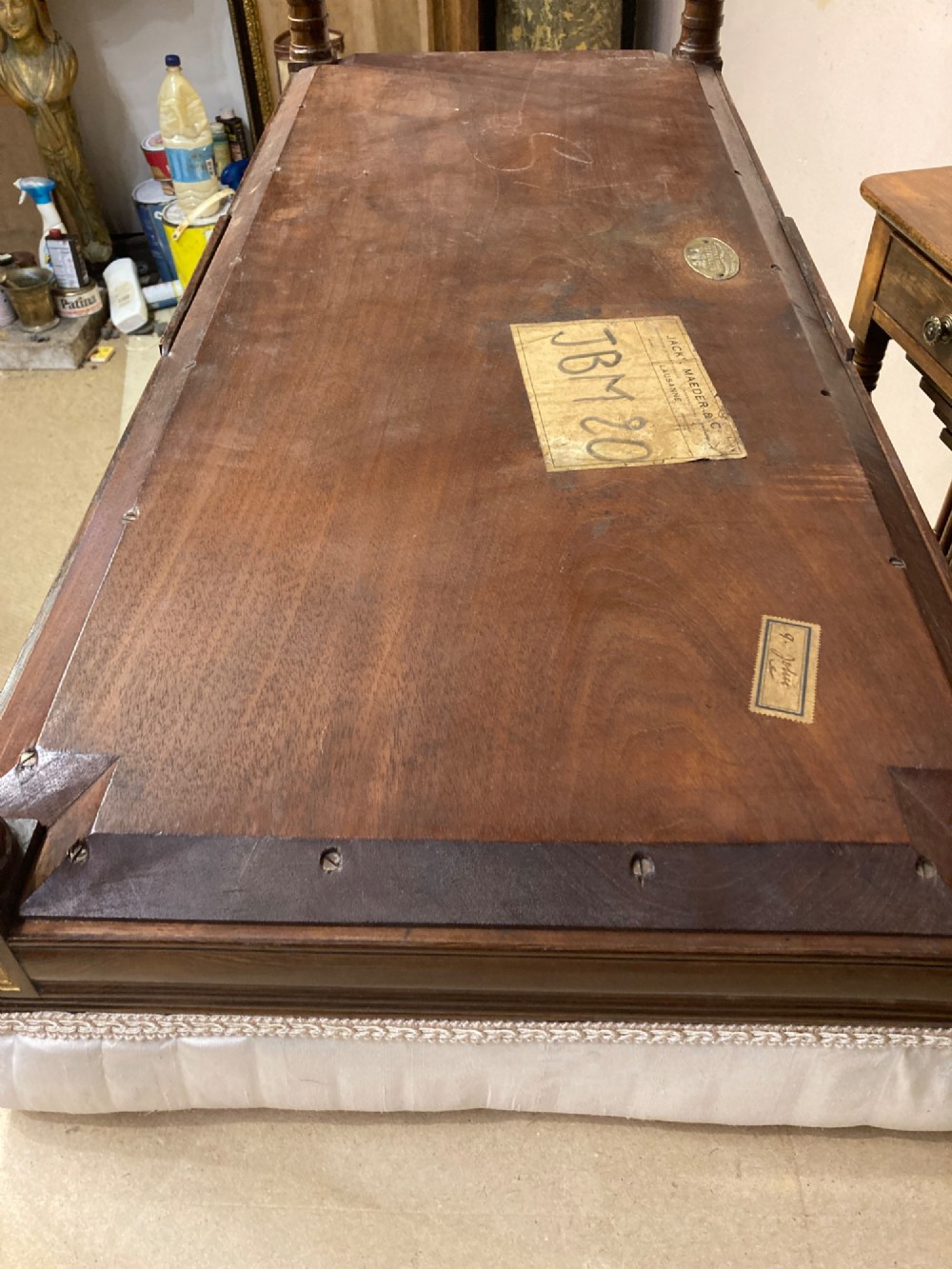 A 19th-century rosewood rectangular music bench featuring a cream upholstered seat, fluted legs, and a gilt decorative central panel on the frieze. View XI