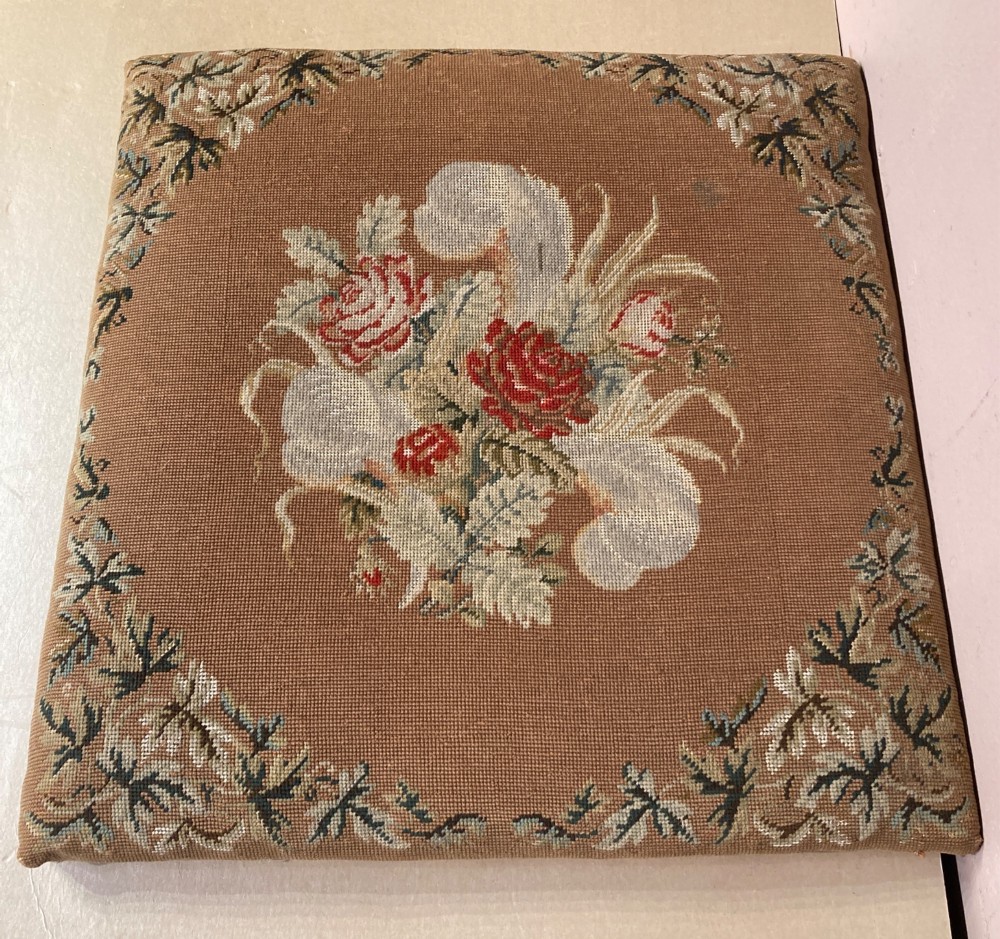 A Victorian rosewood dressing stool featuring carved cabriole legs and a floral needlepoint upholstered seat. View V