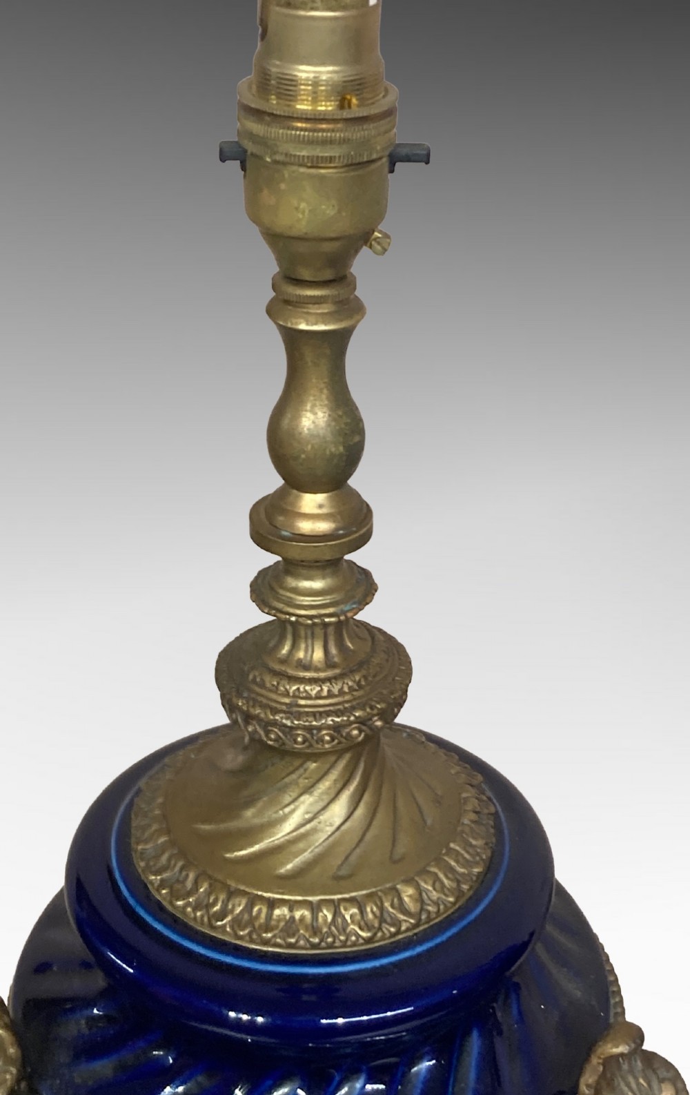 A pair of cobalt blue glazed ceramic urn-shaped table lamps mounted with gilt bronze ram head handles and festoons. View IV