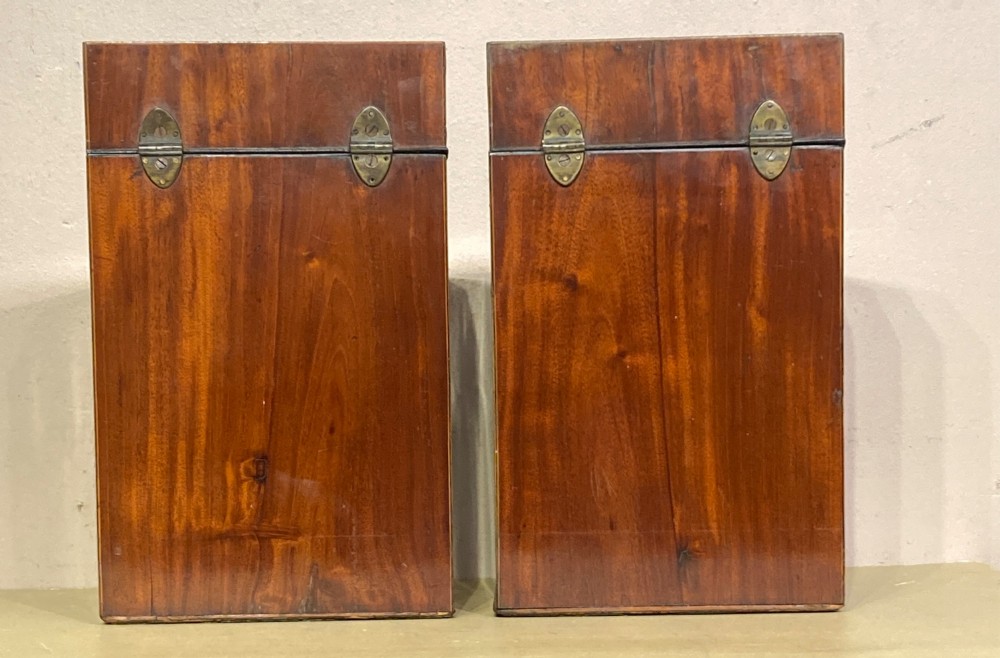 A pair of Georgian mahogany knife boxes featuring sloping lids with oval marquetry shell inlays and serpentine-fronted bodies. View III