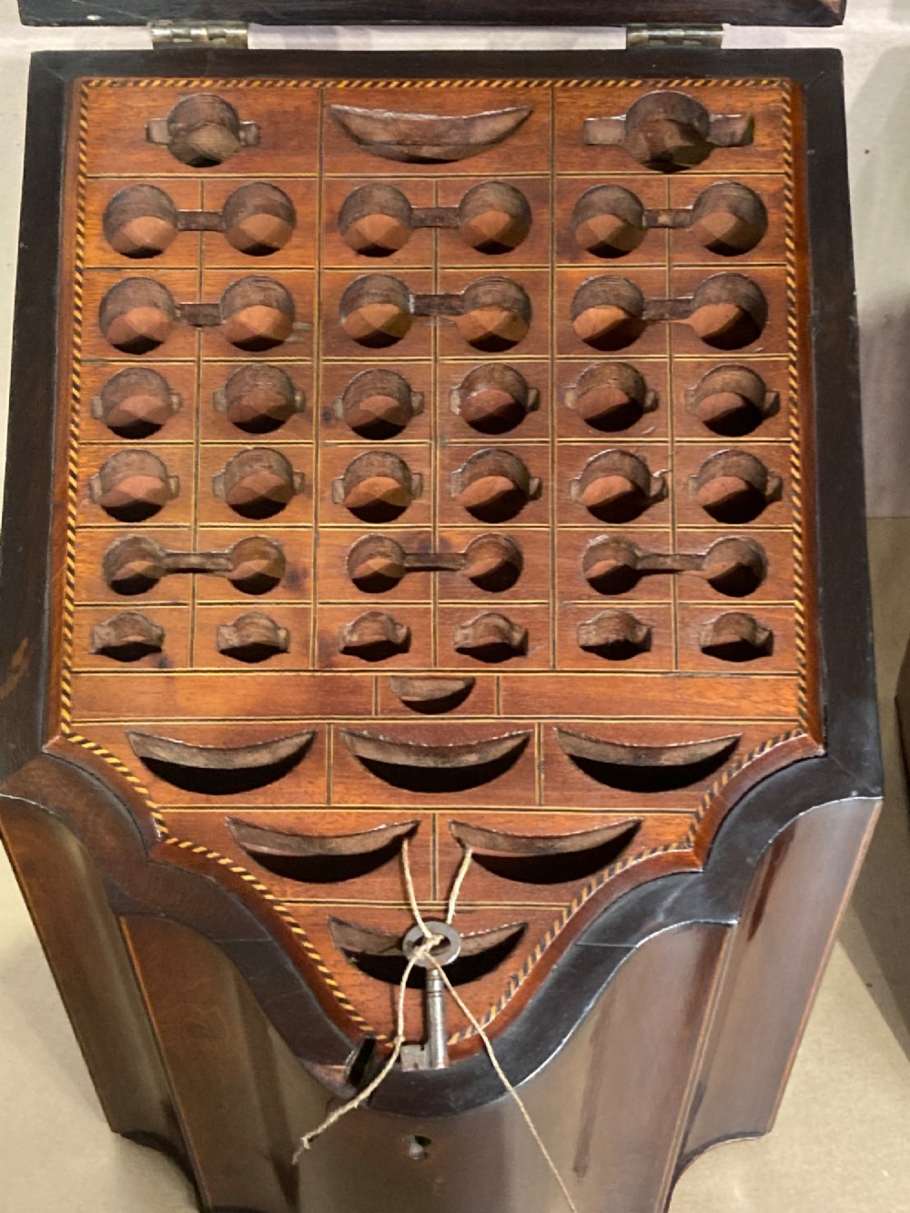 A pair of Georgian mahogany knife boxes featuring sloping lids with oval marquetry shell inlays and serpentine-fronted bodies. View IV