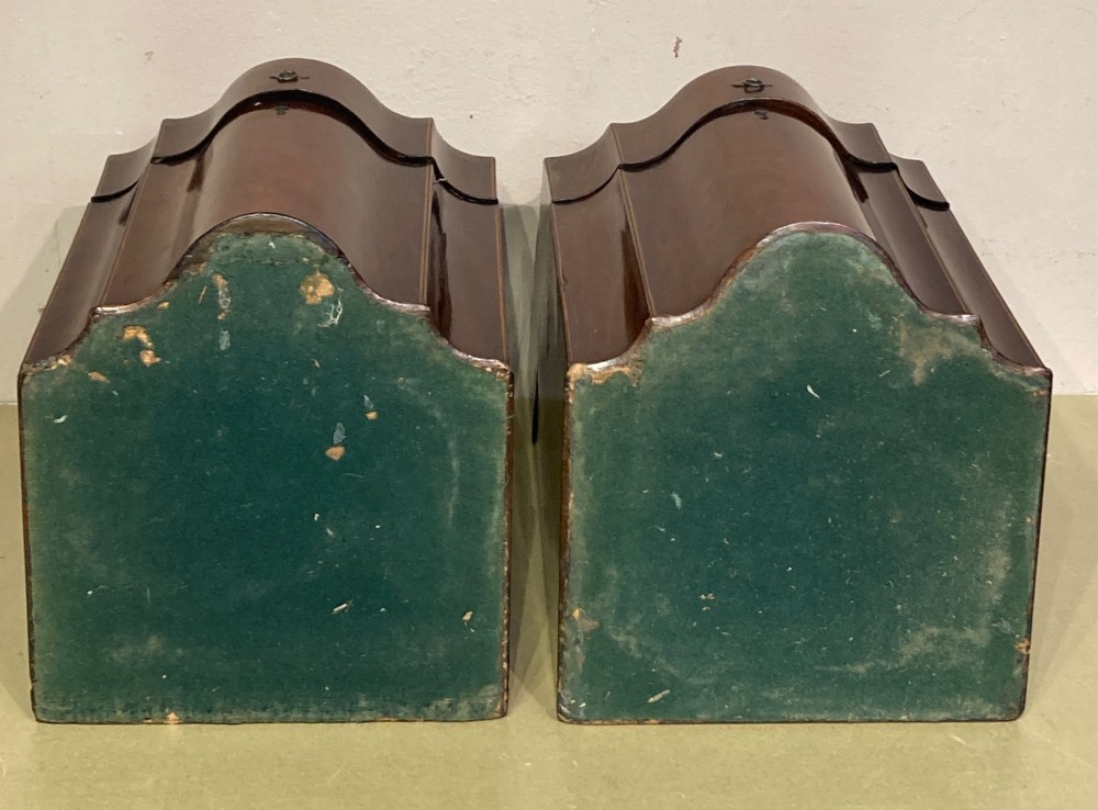 A pair of Georgian mahogany knife boxes featuring sloping lids with oval marquetry shell inlays and serpentine-fronted bodies. View VI