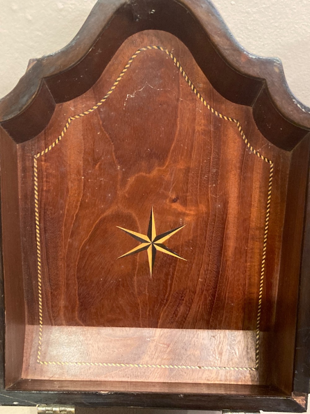 A pair of Georgian mahogany knife boxes featuring sloping lids with oval marquetry shell inlays and serpentine-fronted bodies. View VII