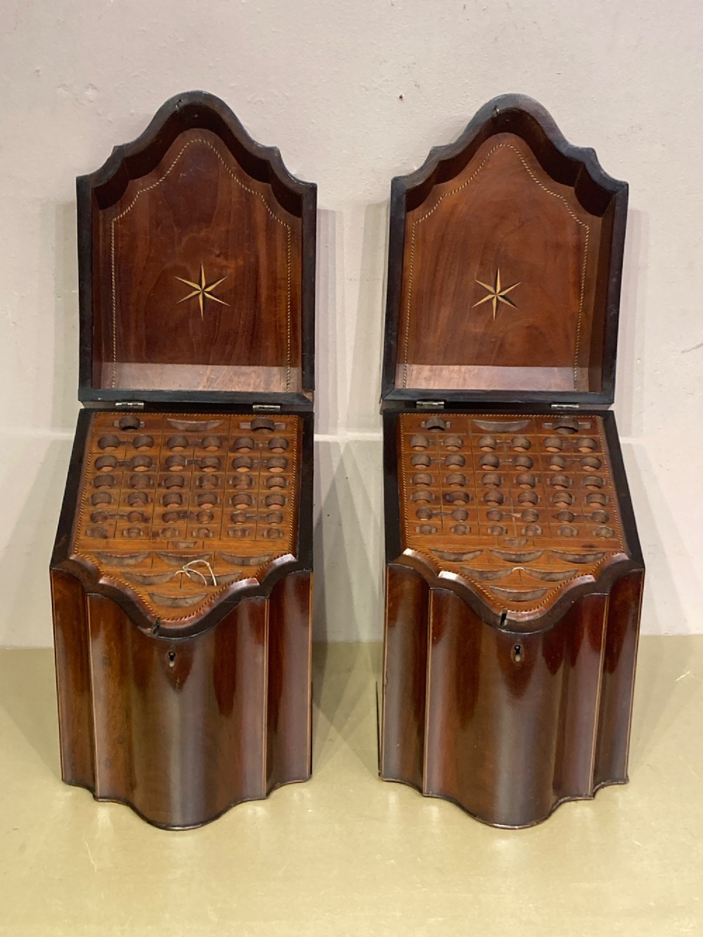 A pair of Georgian mahogany knife boxes featuring sloping lids with oval marquetry shell inlays and serpentine-fronted bodies. View VIII