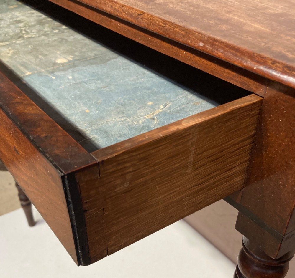 A Georgian mahogany side table featuring a raised gallery top, turned legs, and a single frieze drawer. View III