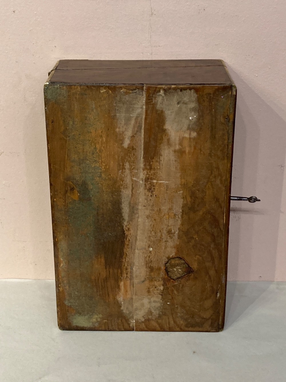 A rectangular Late Georgian burr walnut writing slope box featuring brass edging, an oval brass lid plaque, and a keyhole with key on the front. View VIII