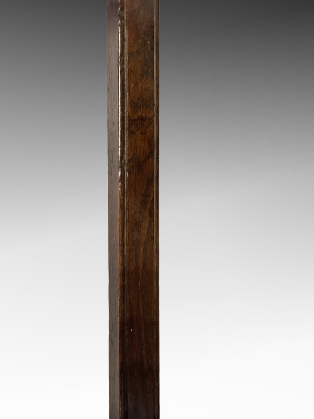 An antique dark oak side table featuring a single drawer with two small brass knobs and square legs connected by stretchers. View VII