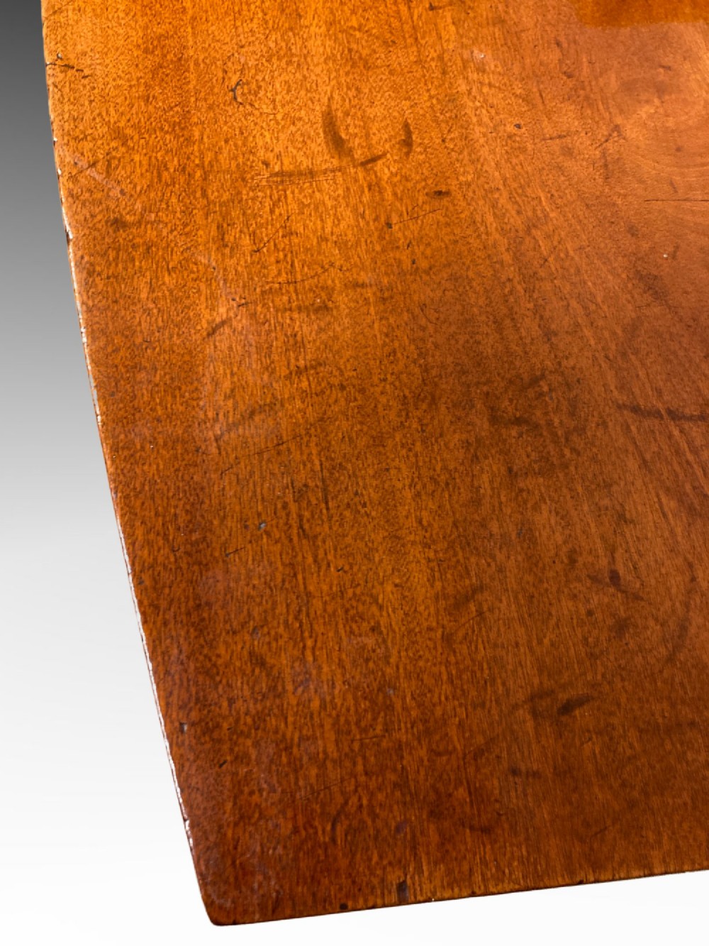 A Georgian mahogany side table featuring a gently curved bow front and four slender square-tapered legs terminating in spade feet. View III
